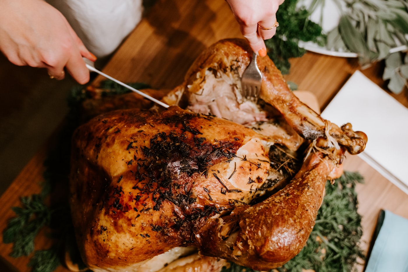 Thanksgiving-style feast table with roast, sides, and wine